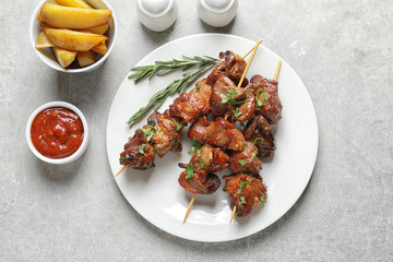 Plate of delicious meat served on gray table, top view