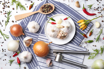 Flat lay composition with garlic, peppers and onions on marble table