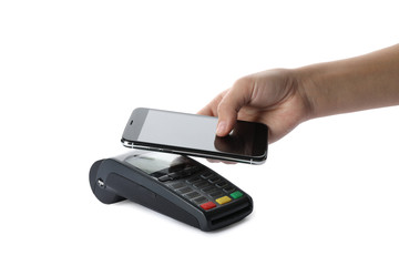 Woman using terminal for contactless payment with smartphone on white background