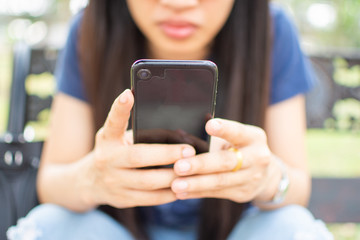 woman's hand holding smart phone with blur background. selective focus and soft focus.