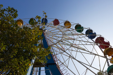Ferris wheel on a background of clear blue sky.