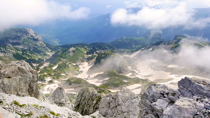 Top of the mountain view of the mountain peaks and valley covered in snow