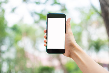 woman's hand holding smart phone with blur background. selective focus and soft focus.