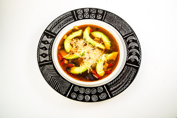 Spicy Tortilla Soup with Sliced Avocado in Bowl with High Contrast Astec Design