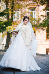 Portrait of beautiful european bride in autumn