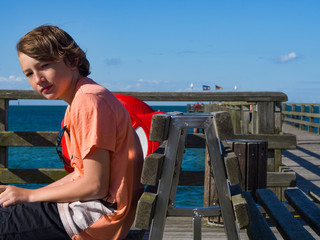 Pensive boy on the coast