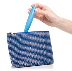 Blue cosmetic bag in hand mascara taking put on white background isolation