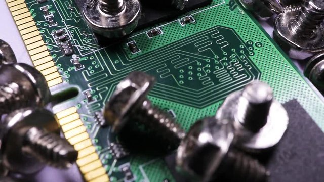 Close up on circuit board and computer screws rotating