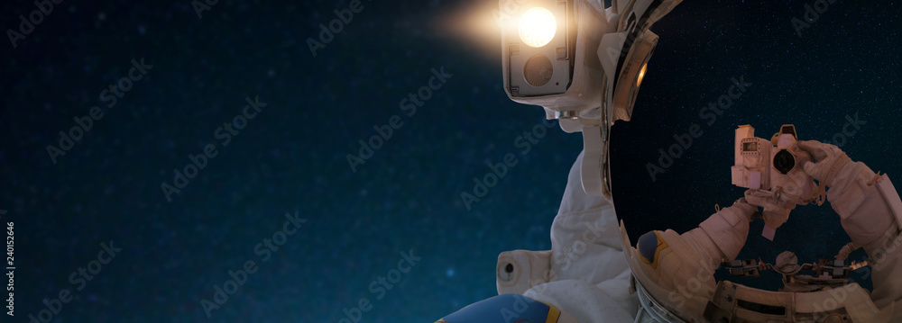 Poster astronaut in outer space takes a selfie on the camera. spaceman travels in space against the backgro
