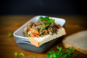 eggplant caviar with tomatoes and a slice of bread