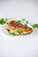 fried omelet with cauliflower and greens in a plate