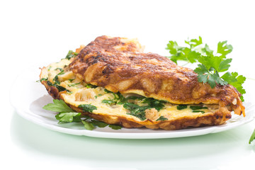 fried omelet with cauliflower and greens in a plate
