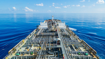 Oil tanker steaming through calm blue sea.
