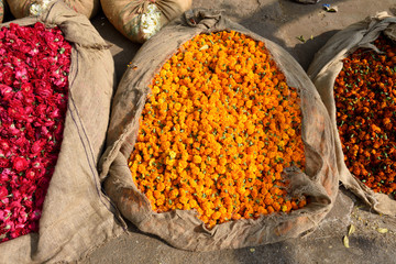 Bags of Indian marigolds and rose flowers in the sunshine, flower market, Jaipur, Rajasthan