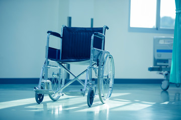 Wheel Chair,Empty wheelchair in the hospital,Wheelchair parked beside the patient bed