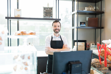 Confident Male Baker Smiling In Store