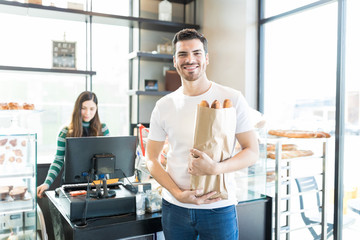 Handsome Customer Shopping For Baguettes