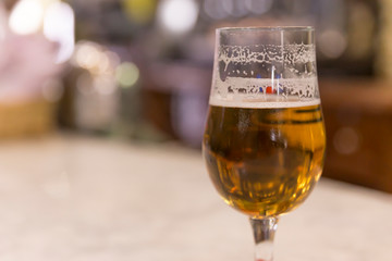 Half full beer, in a bar