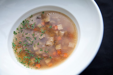 vegetable soup in a round white plate