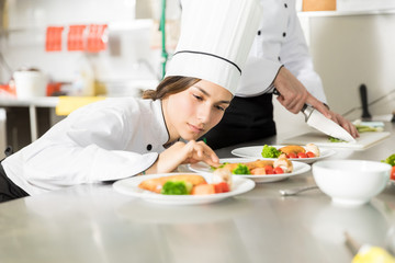 Chef Arranging Basil Leaves In Plate