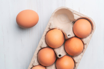fresh eggs in paper tray on white surface b