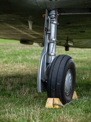 Closeup of plane landing gear and wheel