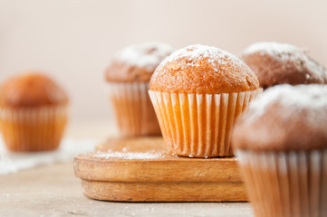Tasty muffin closeup on a wooden board, selective focus. - obrazy, fototapety, plakaty