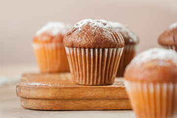 Tasty muffin closeup on a wooden board, selective focus.
