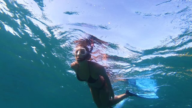 Underwater footage of girl snorkeling with coral reef and tropical fish in the Caribbean Sea