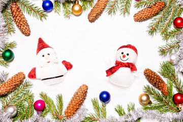 Christmas decoration with Santa Claus and snowman Frame with fir tree branches colorful toys and cones on white background