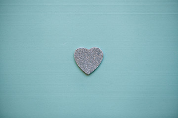 Silver heart on a red background. Concept for Valentine's Day or Women's Day or the topic of...