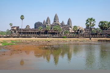Fototapeta premium View of the main temple at Angkor wat. Originally constructed in the early 12th century, the ruins are a huge tourist attraction as well as a place of worship today