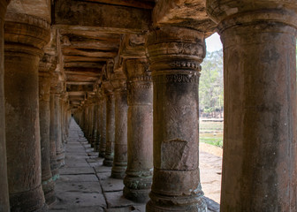 A stone causeway supported by many finely carved columns provides an impressive entrance to the Baphuon temple mountain.