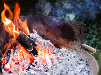 Flaming grill with open fire, ready for product placement. Summer or autumn charcoal, wood grilling, barbecue, bbq and party. Empty device for cook food as meat, seafood apply heat from below. 