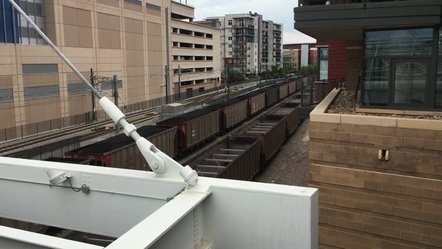 DENVER-JUNE 2015: An empty coal train runs through the city of Denver, Colorado.  Throughout history, coal has been used as an energy resource, primarily burned for the production of electricity and/o