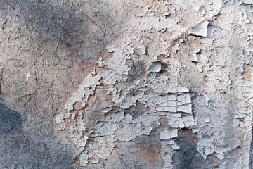Peeling white paint on a concrete stone slab.Texture