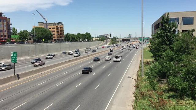 DENVER, COLORADO - June 2015: Shot of Interstate 25 as cars and traffic travel along four lane highway.  A plan in 2015 announced by the Reason Foundation plans to spend $52 billion to alleviate traff