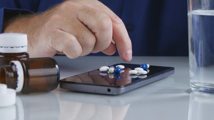 Man Select Medicine Pills from the Smartphone Screen Surface