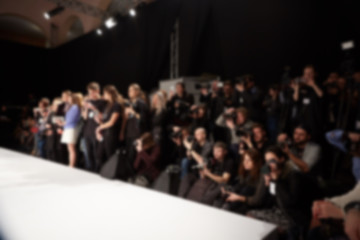 blurred image of group of audience at fashion show stage.