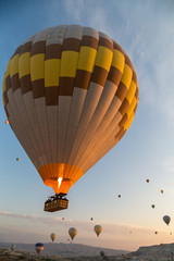 Hot air balloons flying at sunrise