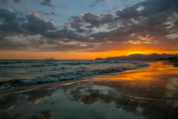 Fototapeta na wymiar Colorful sunset coastline of the Mediterranean Sea with cloudy sky sunset. Summer sunset.