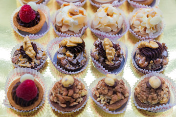 Pastry shop display window with variety of mini desserts and cakes, selective focus