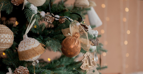 Christmas tree with toys and decorative snow for a happy new year on background of bokee