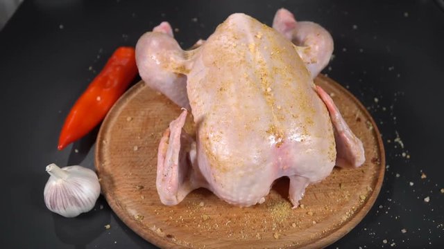 Cook sprinkles chicken with rosemary. slow motion