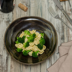 Orecchiette con broccoli. Pasta orecchiette with broccoli on a rustic wooden background