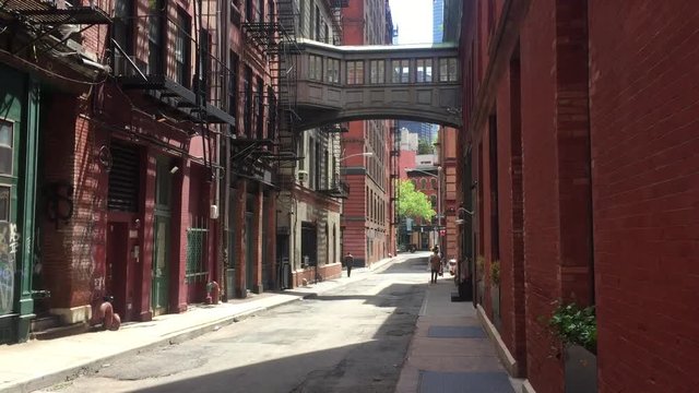 A classic daytime DX establishing shot of empty alley alleyway in New York City Manhattan in summer. Can be used to show suspense, suspicious activity, lofts, shops, danger, lurking