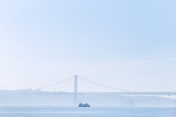 a broad river of Tagus with a beautiful bridge connecting two sh