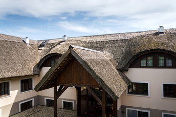 Fototapeta na wymiar Traditional thatched roof from reed, sunny summer day