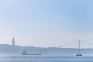 wide navigable river Tagus and silhouettes of the opposite bank