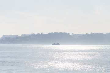Passenger ship on the river Tagus and silhouette of the opposite